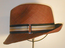 Panama Fedora with Pinch Front and Flip Brim. Accented with Grosgrain Band and Buckle.